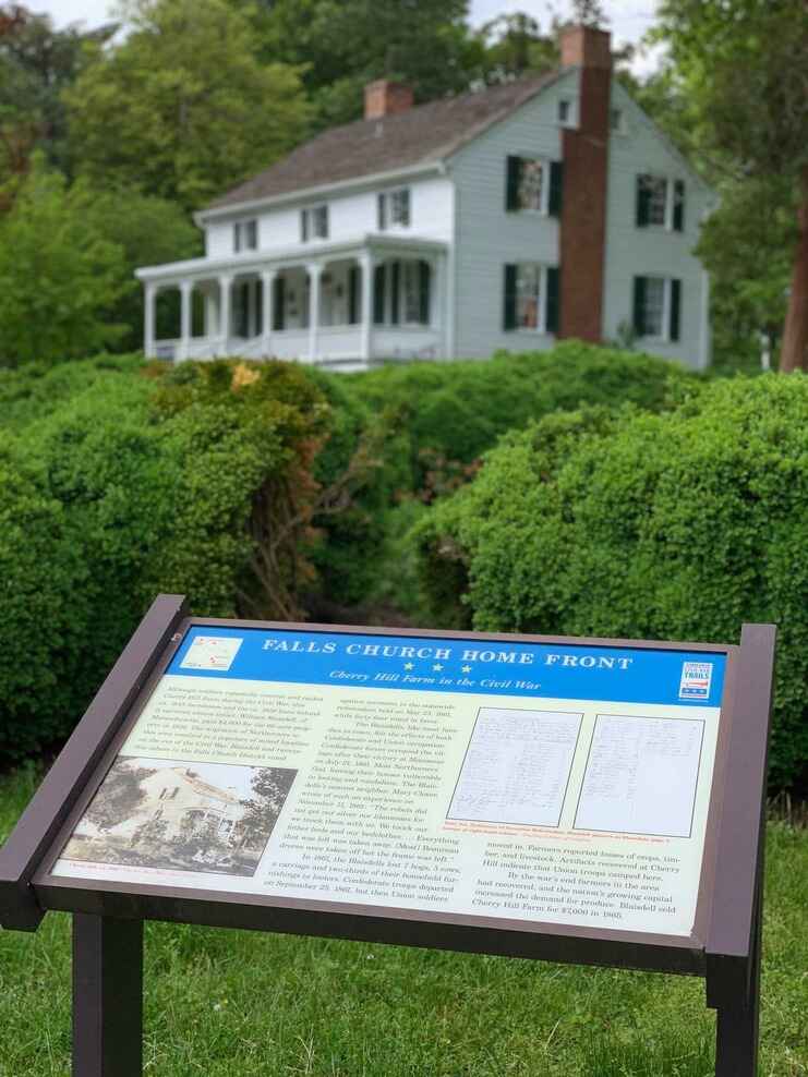 Full color photo Interpretive sign in front of the Cherry Hill Farmhouse.