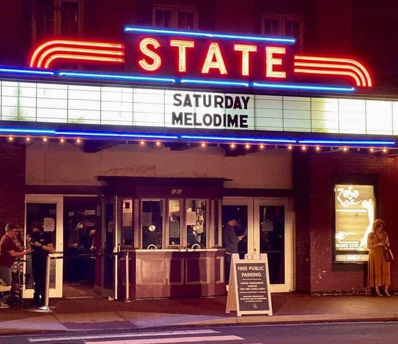 The-State-Theatre-Exterior Full color photo of The State Theatre at night with marquee illuminated saying Saturday Melodime.
